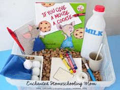 a container filled with lots of food and writing on top of a blue table next to a milk bottle