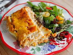 a close up of a plate of food with salad