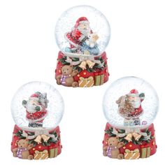 three snow globes with santa claus and teddy bears