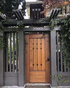 an entrance to a house with wooden doors and trelliss on the front door