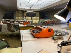 an office filled with lots of desks and chairs