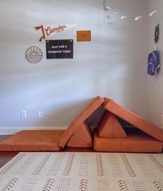 an orange couch sitting on top of a white rug