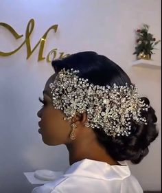 a woman wearing a bridal headpiece in front of a wall with the name mary written on it