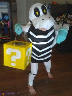 a person in a costume standing next to a box with question mark written on it