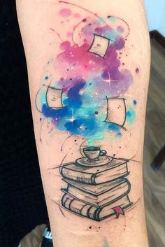 a watercolor tattoo with books on the arm