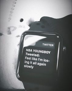 a black and white photo of a watch with the text twitterr on it's screen