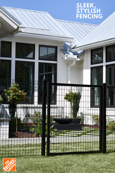 a black fence in front of a white house