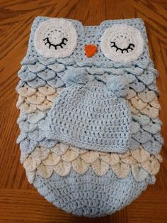 an owl crocheted hat on top of a wooden floor