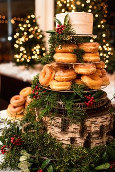 a stack of doughnuts sitting on top of a table next to christmas decorations