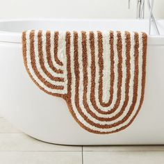 a white bath tub sitting next to a sink