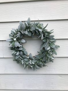 a wreath hanging on the side of a house