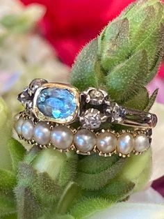 The soft, oceanic hues of this antique aquamarine ring transport one back to the Regency era of Jane Austen.  The luscious blue turquoise color softens and heightens depending on the intensity of the lighting, but the underlying foiling gives a soft glow from within in every type.  Likely English in origin, though mimicking a French design. Size 6. A very rare collector's piece! Luxury Light Blue Aquamarine Rings, Elegant Blue Multi-stone Emerald Ring, Luxury Blue Topaz Ring With Rose Cut Diamonds, Heirloom Blue Sapphire Ring With Rose Cut Diamonds, Oval Blue Multi-stone Emerald Ring, Luxury Blue Topaz Rings With Rose Cut Diamonds, Oval Aquamarine Ring With Rose Cut Diamonds, Oval Aquamarine Rings With Rose Cut Diamonds, Luxury Blue Multi-stone Topaz Ring