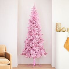 a pink christmas tree in a living room