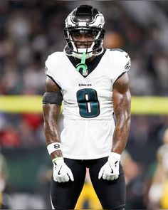 a football player in uniform standing on the field