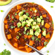 a white bowl filled with black bean and vegetable soup