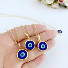 Ward off bad vibes in style with our Blue Turkish Evil Eye Necklace. Perfect for any occasion (except maybe a séance), this necklace features a stunning blue evil eye charm on a delicate chain. Keep the negativity away, all while looking fabulous. This necklace is combination of; - dark blue glass evil eye bead - stainless steel gold chain 15mm Charm Made in Turkey Blue Evil Eye Charm Necklace, Spiritual Blue Evil Eye Jewelry, Blue Pendant Charm Necklaces For Spiritual Style, Blue Evil Eye Jewelry As Gift, Blue Evil Eye Jewelry Gift, Handmade Blue Round Charm Necklace, Blue Evil Eye Pendant Necklace, Spiritual Blue Charm Necklace With Adjustable Chain, Blue Pendant Charm Necklace With Adjustable Chain