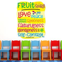 colorful chairs in front of a wall that says fruit spirit