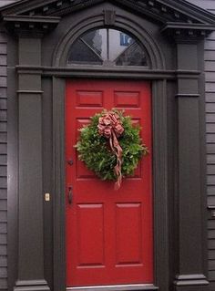 a red door with a wreath on it