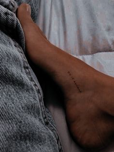 a person's foot with the word love written on it in cursive writing