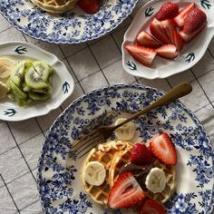 three plates with waffles, bananas and strawberries on them