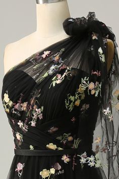 a dress on a mannequin with flowers all over it