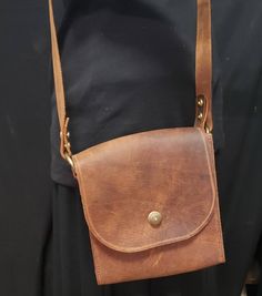 "Handcrafted Leather shoulder purse! Created from top grain cowhide. This beautiful brown leather shoulder bag is rustic yet rugged. The bag itself is 7\" high x 7\" wide by 3\" deep, a perfect size for a quick outing with its adjustable shoulder strap! Handcrafted by me in my NC studio and finished with stylish brass rivets and a lock closure. Hand sewn. Everything hand done by me in my North Carolina studio." Brown Oiled Leather Shoulder Bag, Artisan Brown Vegetable-tanned Shoulder Bag, Handmade Rustic Shoulder Bag For Everyday Use, Rustic Handmade Shoulder Bag For Everyday Use, Rustic Leather Shoulder Bag For Everyday Use, Rustic Crossbody Bag For Everyday Use, Rustic Handmade Bags For Everyday Use, Rustic Brown Crossbody Bag, Rustic Leather Crossbody Bag