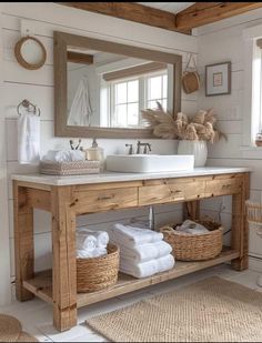 a bathroom with two sinks, mirrors and baskets on the counter in front of it