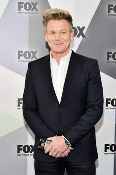 a man in a black suit and white shirt