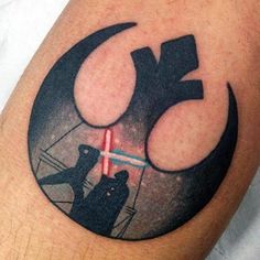 a star wars tattoo on the leg of a person with a light saber in his hand