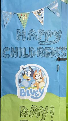 a child's blue and green bulletin board with the words happy children's day written on it