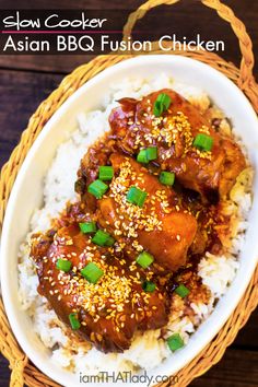 a bowl filled with rice and meat covered in sesame seeds, green onions and sauce