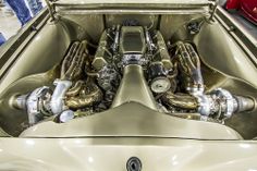 the engine compartment of an old car in a showroom