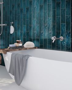 a bath tub sitting next to a shower head