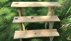 three wooden benches sitting in the grass