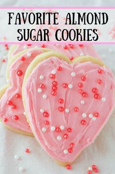 two heart shaped sugar cookies with pink frosting and sprinkles on top