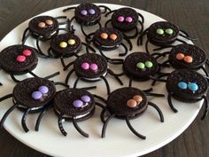 there are chocolate spider cookies on the plate