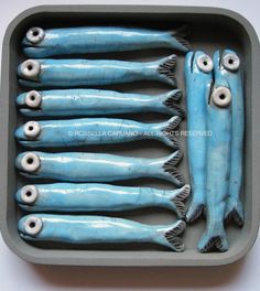 five blue fish in a tray with googly eyes