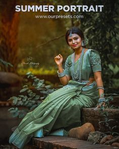 a woman is sitting on some steps in the woods with her hand up to her mouth