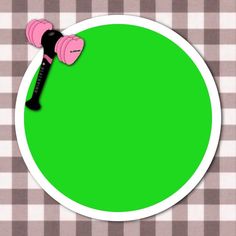 a green plate with a black and pink object in the middle on a checkered table cloth