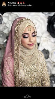 a woman wearing a hijab and gold makeup