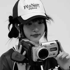 black and white photograph of a woman holding a camera