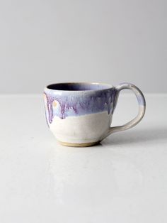 a white and blue cup sitting on top of a table