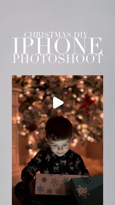 a young boy opening a christmas present in front of a tree with the words, christmas diy iphone photoshoot