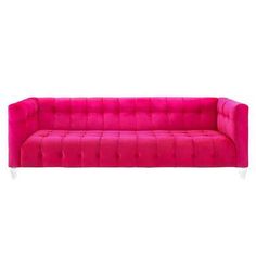 a pink couch sitting on top of a white floor