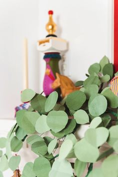 green leaves are arranged in front of a mirror