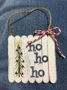 a wooden sign that says no ho hoo with a christmas tree on the front