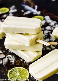 several popsicles with limes and ice on top in a frying pan, ready to be eaten