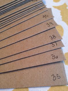 six brown paper tags with numbers on them