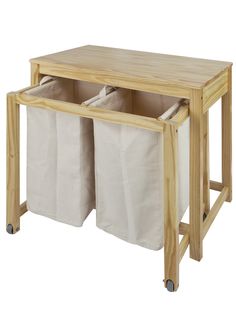 a wooden table with two bins on it and one is holding white bags in the middle