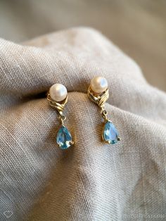 *Gemstone Dangle Earrings *14k Gold *Blue Topaz, Genuine *Pearl, Freshwater Cultured *5.0 x 7.5 mm topaz *6 mm pearls ☞ Some fine jewelry items may show patina or signs of age or wear in photos. Rest assured, your jewelry will be carefully cleaned and polished prior to shipping! If you would like the natural patina left on, send us a note! Quality You Can Trust *Authenticated by a GIA Graduate Gemologist  *Detailed Quality Control and Careful Restoration *5 Star Customer Service. Questions? Send Vintage Pearl And Diamond Earrings, Pearl Dangle Earrings, Pearl And Diamond Earrings, Blue Topaz Earrings, Recycled Jewelry, Retro Jewelry, The 1990s, Topaz Earrings, Pearl Earrings Dangle